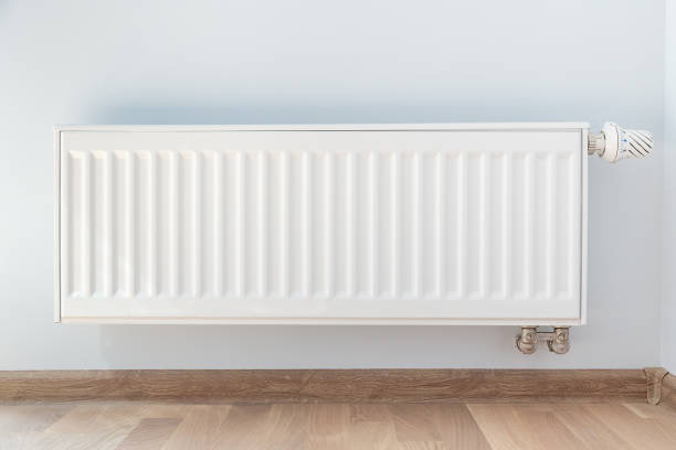 istock Interior detail. White metal radiator on white wall 1060938842