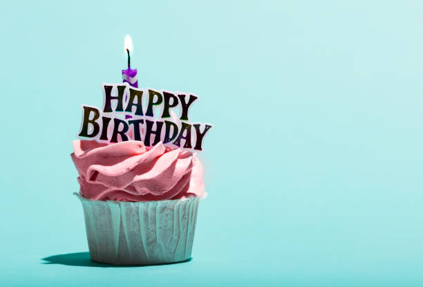 istock Birthday muffin with candle on a blue background. 1060939454