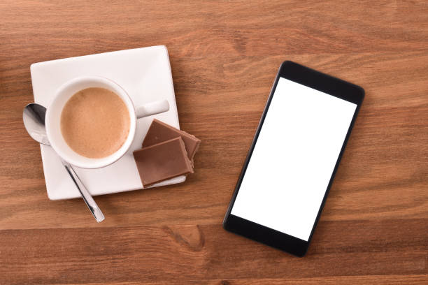 istock Mobile phone in rest time with coffee and chocolate 1060939916