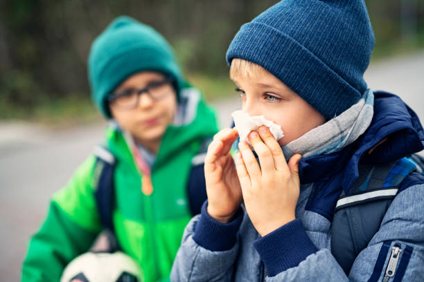 istock Sick boy going to school and cleaning nose 1060941818