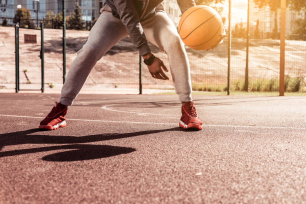 istock Nice young man holding a basketball ball 1060956824