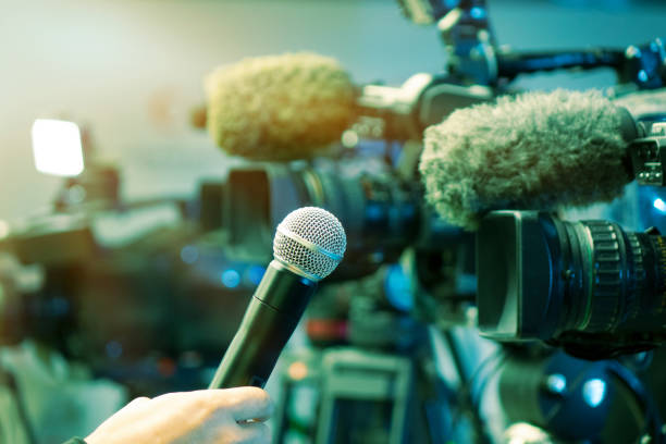 News conference. Filming an event with a video camera and a microphpne. Newspaper, Home Video Camera, Convention Center, Working, UK camera covers pictures stock pictures, royalty-free photos & images