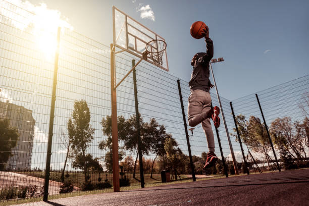 istock Handsome Afro American man throwing a ball into the basket 1060956876