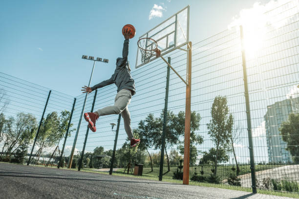 istock Low angle of a nice young man throwing the ball 1060956884