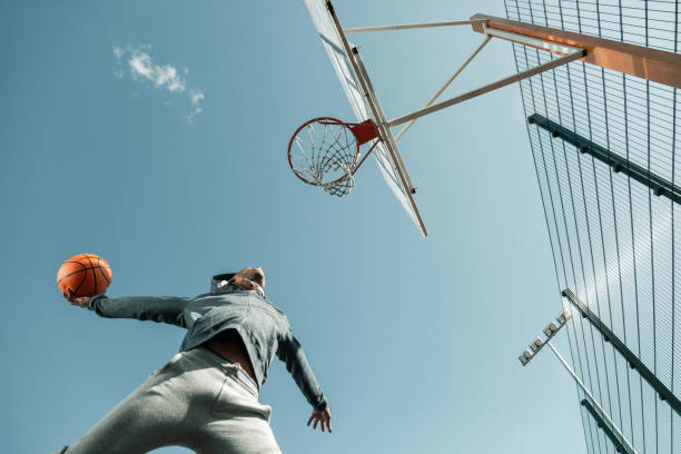 istock Low angle of a basketball player jumping 1060956944