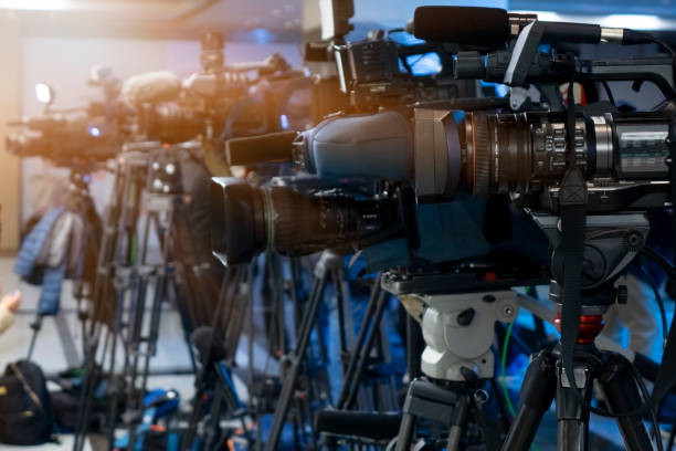 istock News conference. Filming an event with a video camera. 1060958966