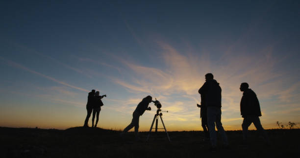 istock Friends stargazing together using a professional telescope 1060959226