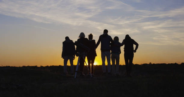istock Friends together in the setting sun cheering 1060959354