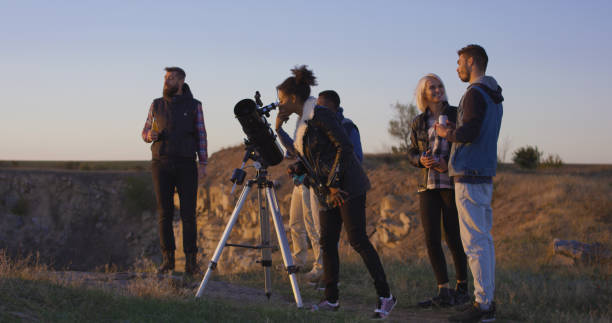 istock Friends stargazing together using a professional telescope 1060959418