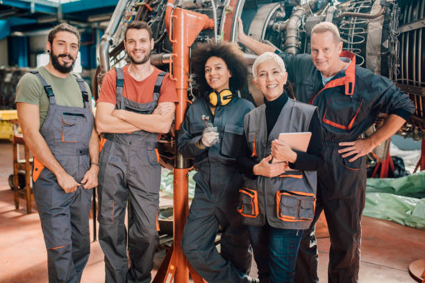 istock Happy people working at airplane hangar 1060965068