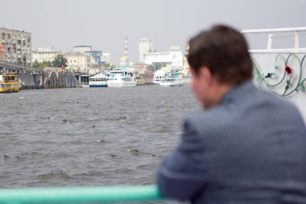 middle-aged man on the river pier looks into the distance