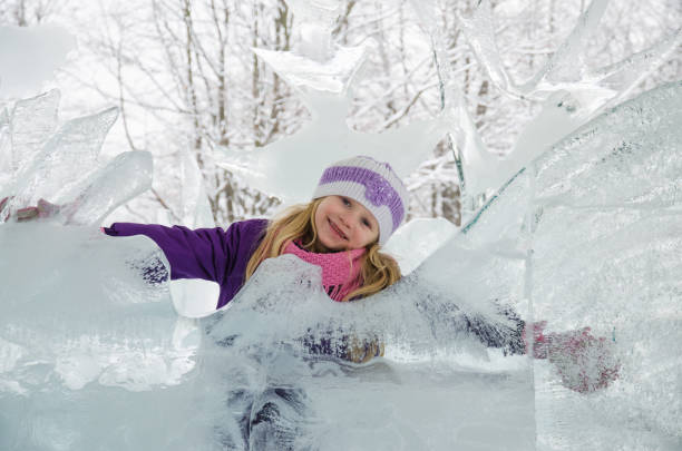 child in icy kingdom in winter time stock photo