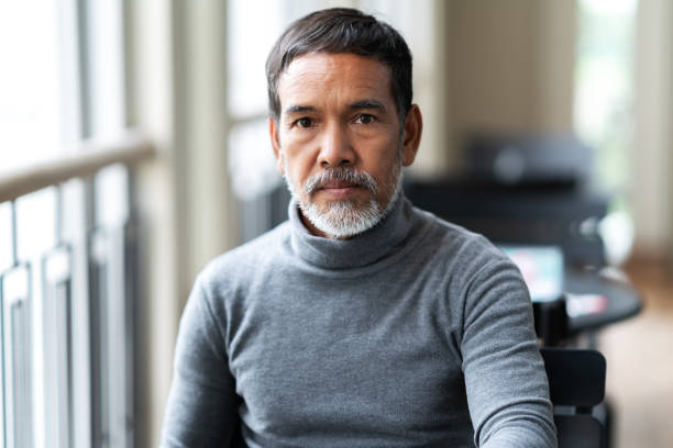 portrait of unhappy angry mature asian man with stylish short beard looking at cemera with negative suspicious. casual retired hispanic people feeling worry or unpleasant at outside cafe concept. - portrait men senior adult depression imagens e fotografias de stock