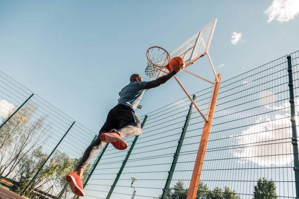 istock Nice strong young man playing basketball alone 1060970004
