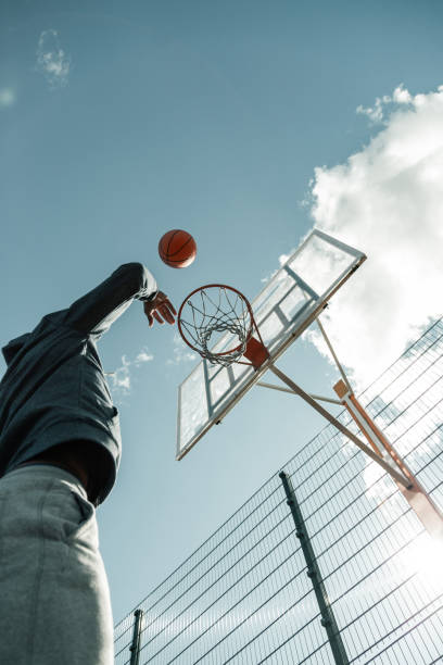 istock Low angle of a ball flying to the basket 1060970068