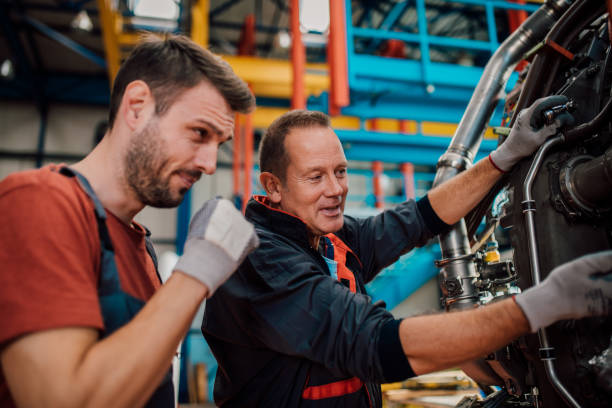 istock Smiling men repairing aircraft 1060970158