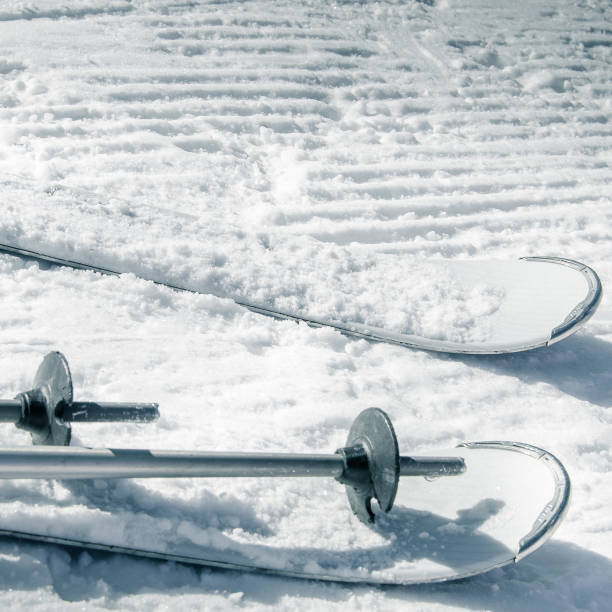 istock Square background with white skis and ski poles 1060970198