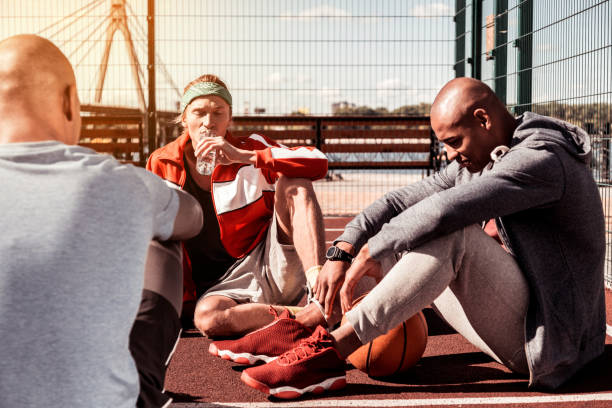 istock Pleasant good looking men resting together after the match 1060970262