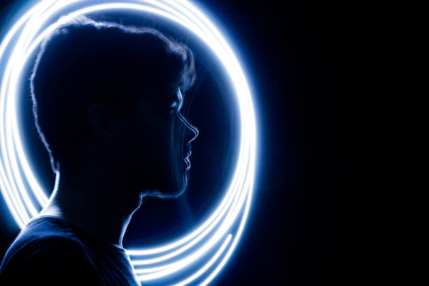 wireframe human profile face portrait on blue, technological background. circle light painting, man silhouette - light shadow lighting equipment inspiration imagens e fotografias de stock