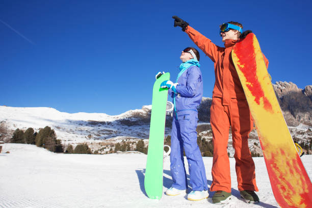 istock two snowboarders on top of the mountain 1060981732