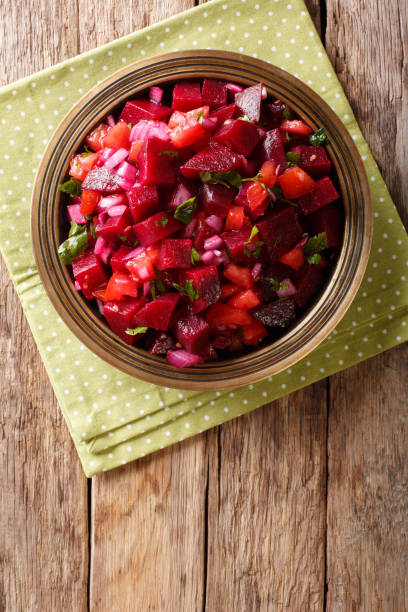 istock Moroccan beetroot salad with onions, tomatoes and herbs close-up.Vertical top view from above 1060984082