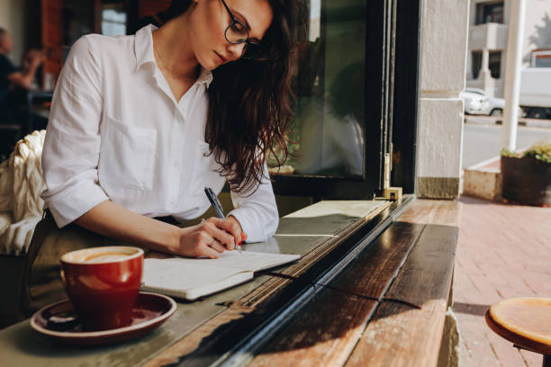 istock Woman taking notes in the cafe 1060987680