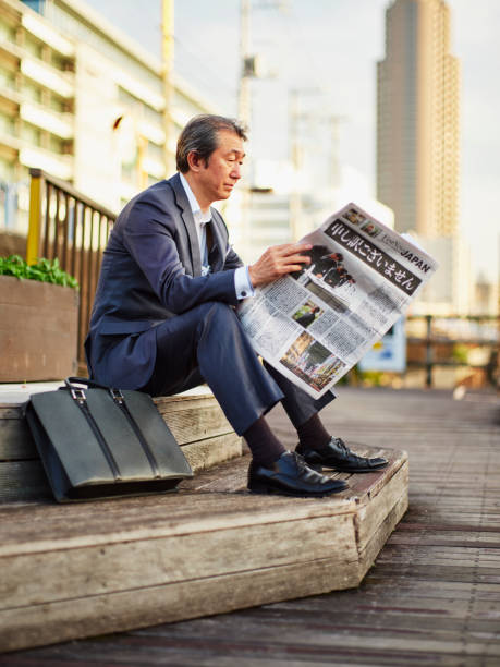 istock Japanese Man with Newspaper 1060990786