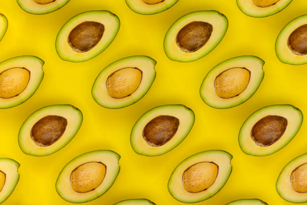 istock Avocado on the yellow background. Top view 1060991560
