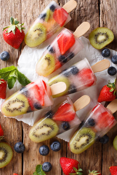 Natural berry-fruit ice with fresh strawberries, blueberries and kiwi fruit close-up. Vertical top view