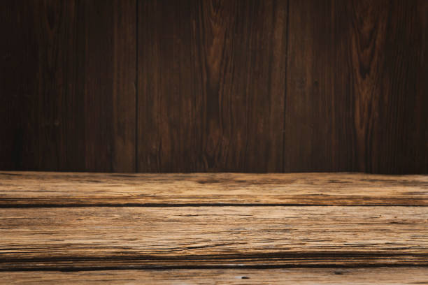 istock Empty wood table with dark vertical wooden background 1060991722