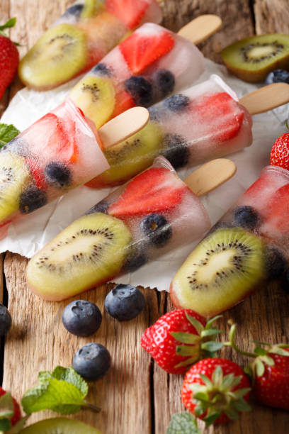 istock Homemade popsicles with berries and fruits close-up. vertical 1060992996