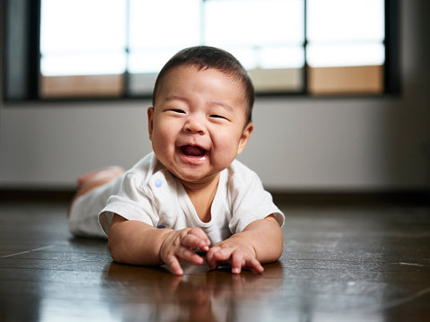 A six month old Japanese baby boy inside a home.