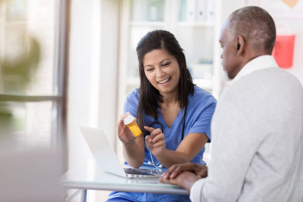istock Senior patient watches nurse explain prescription 1060998620