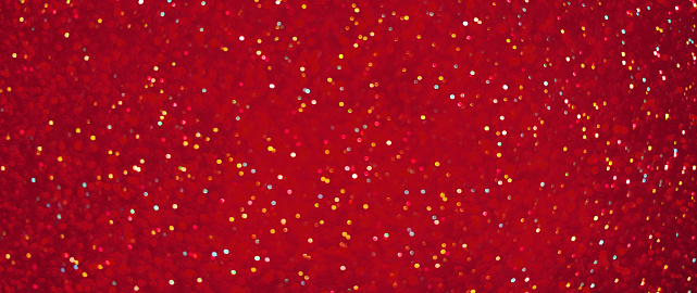 Beautiful bright Red Festive glamour Background. Holiday Background with lots of multicolored confetti. Wide Angle Background Party for design to New years eve, Christmas, birthday or Valentine's day