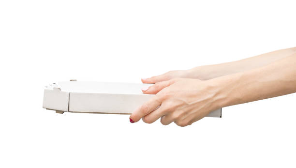 istock Woman's hands holding pizza box. Isolated on white. 1060998894