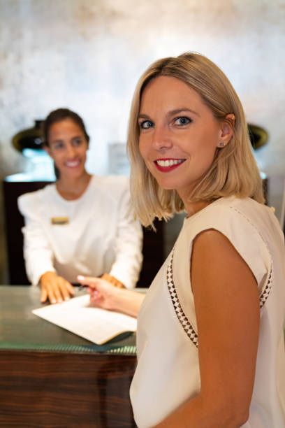 istock Traveling woman doing the check-in at a hotel 1061002534