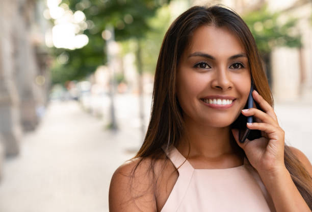 istock Woman outdoors talking on the phone 1061002576