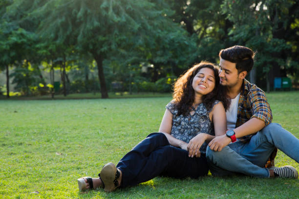 istock Couple Sitting In park - Stock image 1061002714