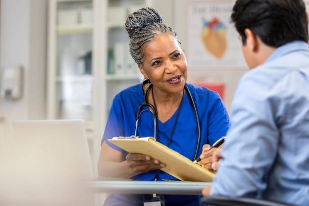 istock Senior nurse explains paperwork to new patient 1061005648