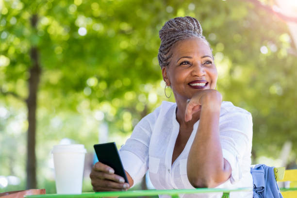 Senior woman enjoys a quiet moment at a park table