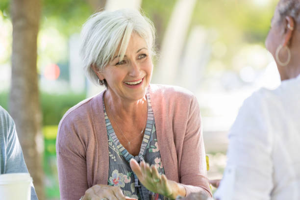 A beautiful senior woman laughs with her friends