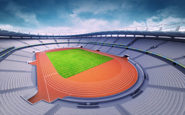 istock empty athletics stadium with track and grass field at upper day view 1061010046