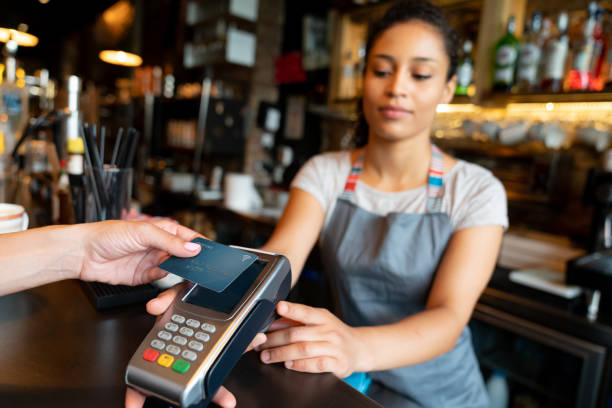 istock Woman making a contactless payment at a cafe 1061010102