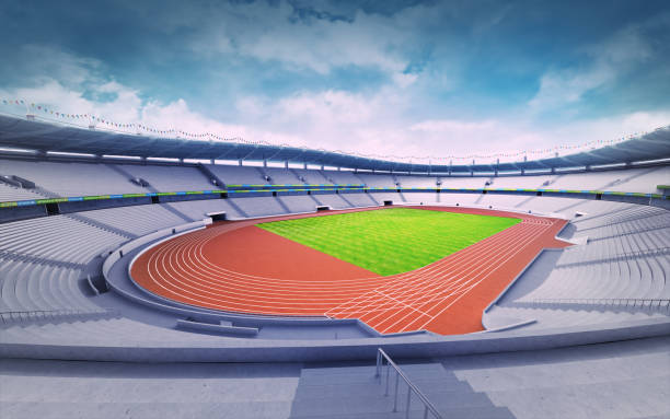 istock empty athletics stadium with track and grass field at corner view 1061010126