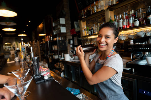 feliz bartender mezcla bebidas en el bar - servir comida y bebida fotografías e imágenes de stock