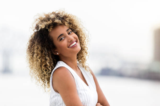 istock Beautiful young woman smiles for camera with head back 1061010562