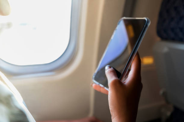 istock Unrecognizable commercial airline passenger uses smart phone 1061010590