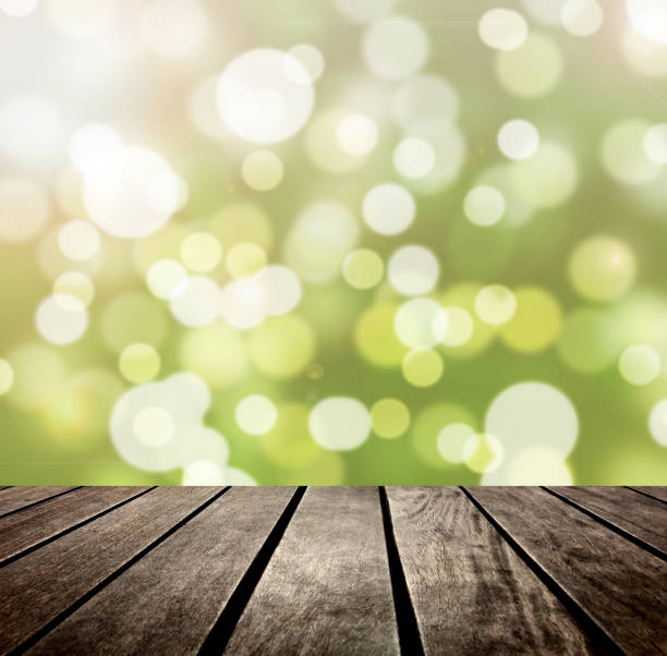 istock Green bokeh and wooden plank 1061013020