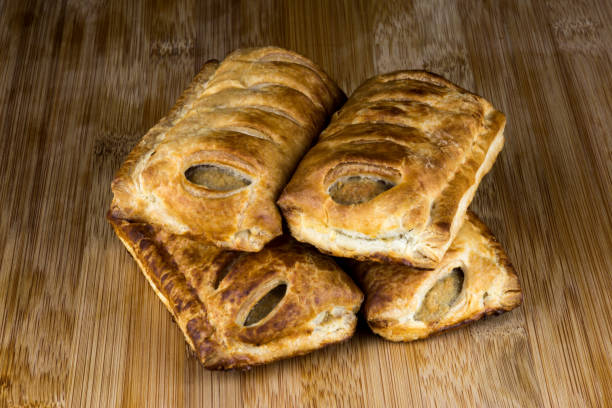 istock Sausage Rolls on a Wooden Surface 1061014246