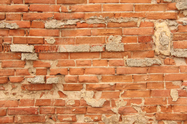 istock Old Wall of Red Bricks and White Brayed and Cracked Old Paint. Red, Terracotta and White Brick Background. Old Wall for Background, Design, Design and Template 1061016026